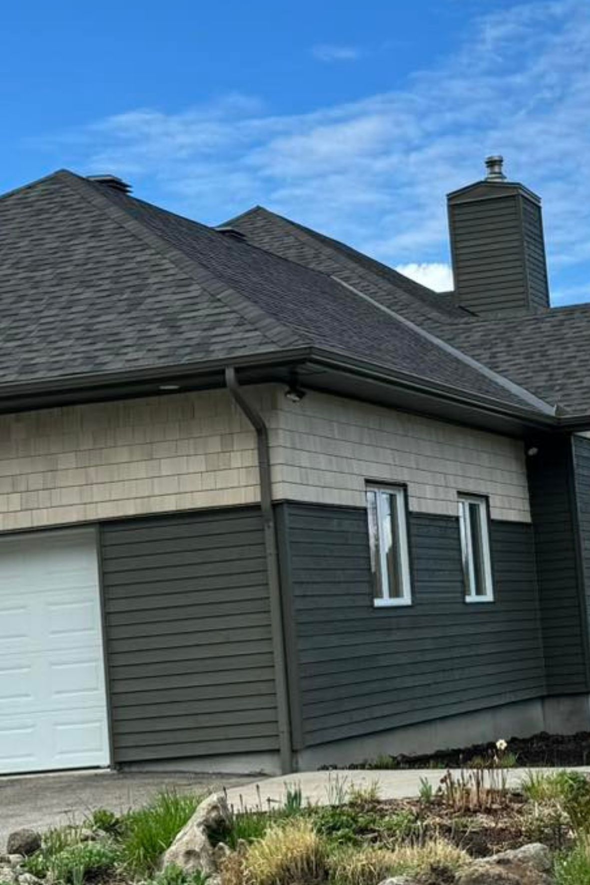Maison avec toiture en bardeaux, gouttières et revêtement extérieur visibles sur façade en Outaouais